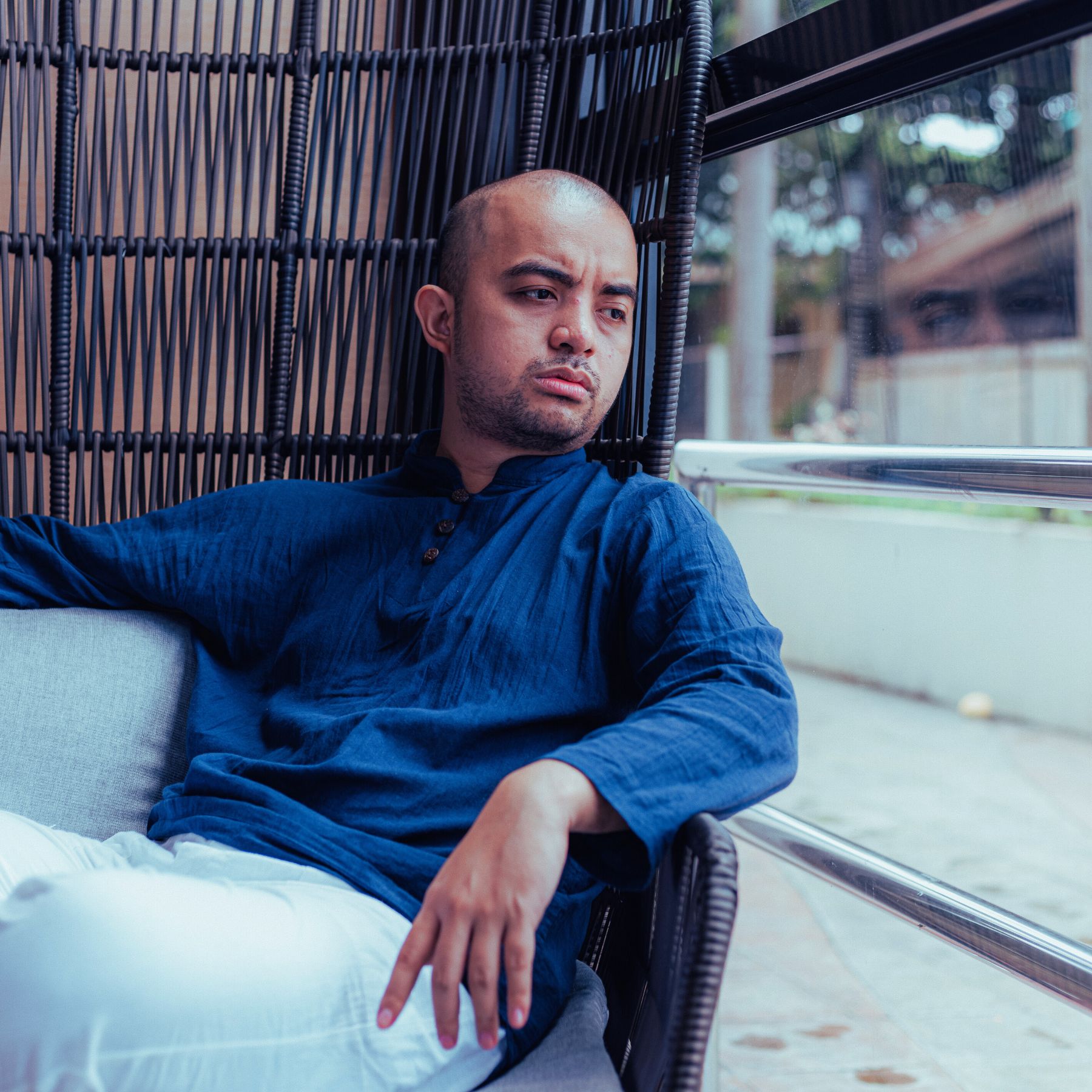 man sitting looking concerned and solemn, anxiety