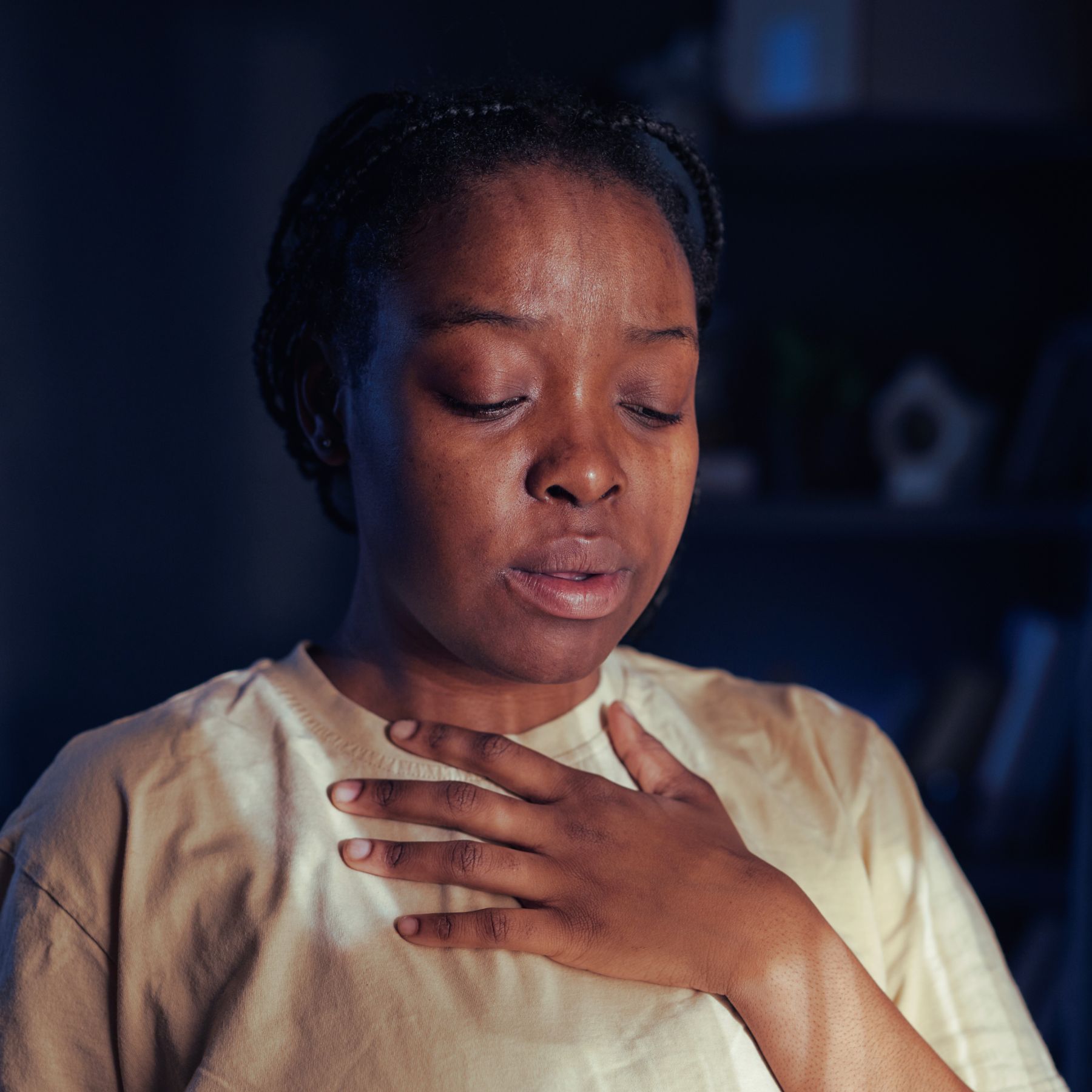 woman with hand clutched to chest, distressed, pts